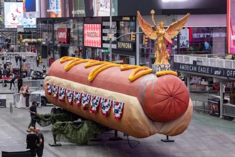 Artists’ monumental hot dog sculpture, now with patriotic toppings, returns to Times Square